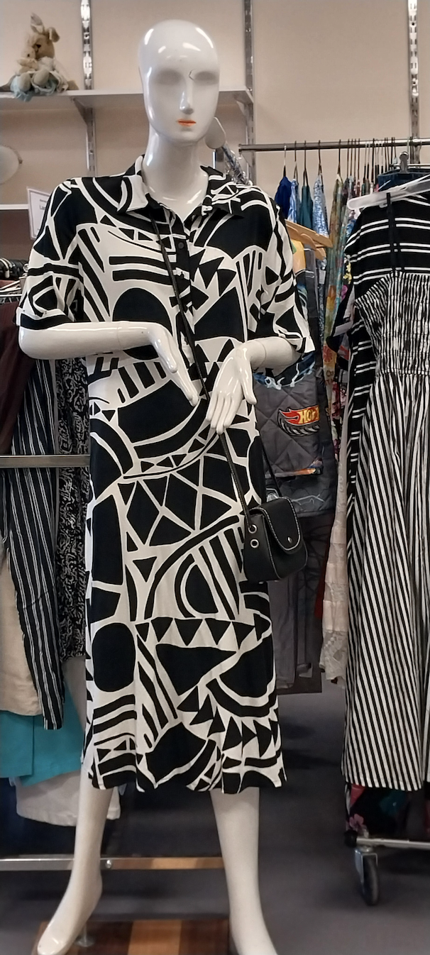 A mannequin wearing a black and white geometric pattern dress